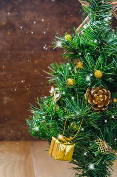 Christmas background with decorations and gift boxes on wooden board