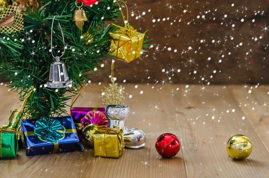 Christmas background with decorations and gift boxes on wooden board