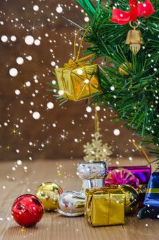 Christmas background with decorations and gift boxes on wooden board