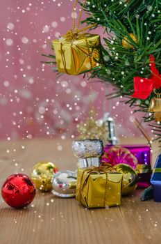 Christmas background with decorations and gift boxes on wooden board