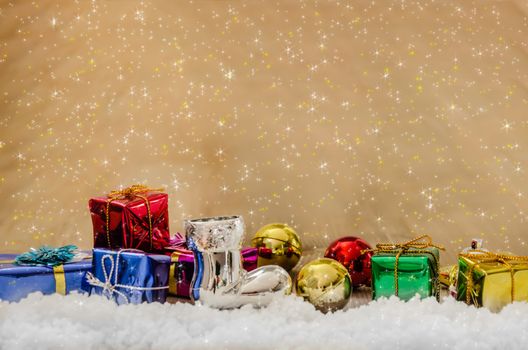 Christmas background with decorations and gift boxes on wooden board