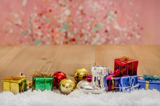 Christmas background with decorations and gift boxes on wooden board