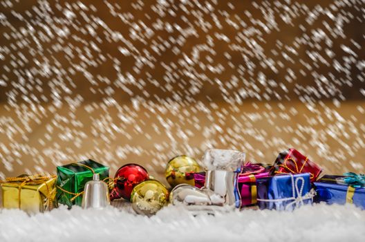 Christmas background with decorations and gift boxes on wooden board
