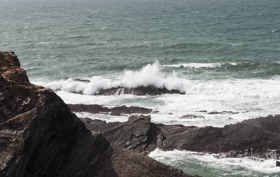 water splashing on the rocks at the atlantic ocean