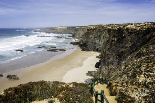 the brown golden rocks of alentejo with the atlantic ocean and beach of potugal