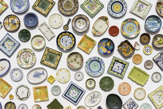 background of typical Portuguese ceramics in red green yellow on white wall in sagres Portugal