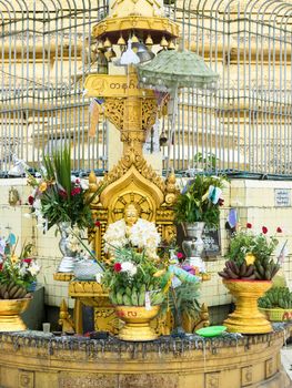 Buddha image decorated with flowers at the Botahtaung Pagoda in Yangon, Myanmar