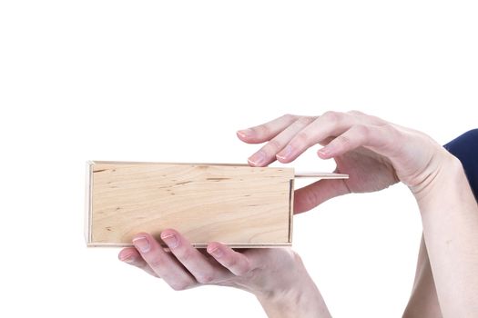 Hands of woman open wooden box on a white background