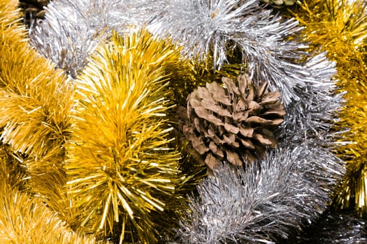 Silver and gold Chistmas tinsel with Pine Cones