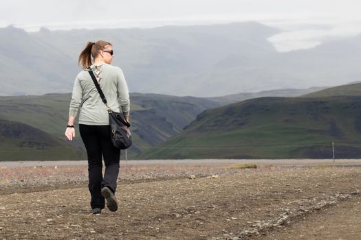 Woman hiker walking in mountain landscape, Iceland