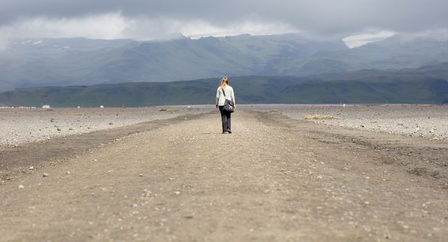 Woman hiker walking in mountain landscape, Iceland