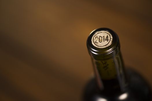 Close-up of closed wine bottles lying on blurry background, winery