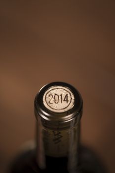 Close-up of closed wine bottles lying on blurry background, winery