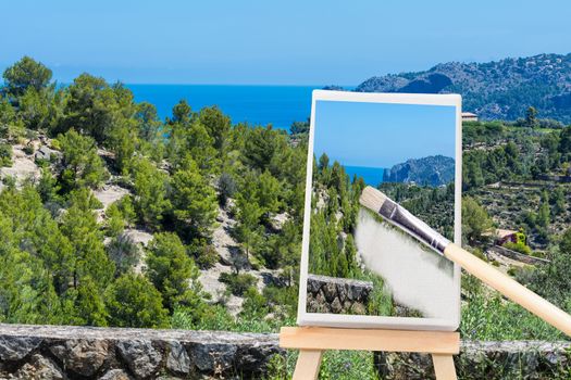 Painted canvas stands on an easel. On the screen, a holiday landscape with ocean in the background.