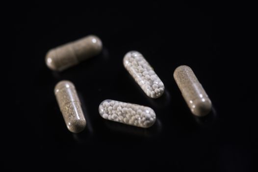 Fiber natural pills, phytotherapie on black background