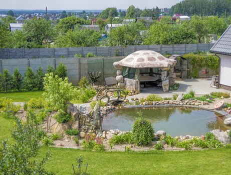 dacha with original gazebo artificial pond and greenery