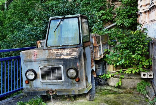 Old abandoned and rusted empty truck on dump.