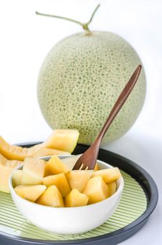 freshly cut cantaloupe melon on white background