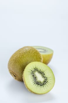 delicious whole kiwi fruit and half on white background