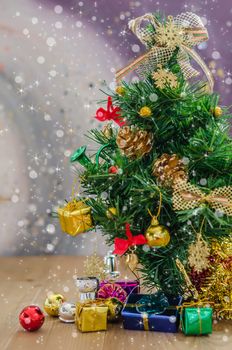 Christmas background with decorations and gift boxes on wooden board