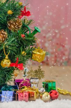 Christmas background with decorations and gift boxes on wooden board