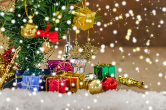 Christmas background with decorations and gift boxes on wooden board