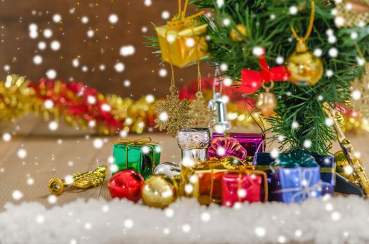 Christmas background with decorations and gift boxes on wooden board