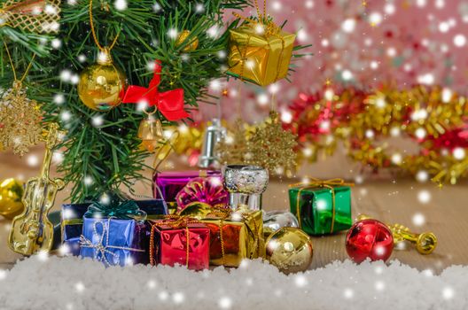 Christmas background with decorations and gift boxes on wooden board