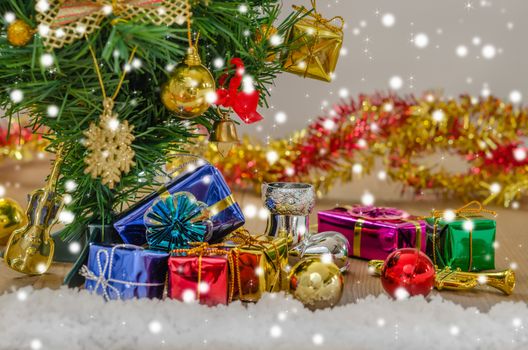 Christmas background with decorations and gift boxes on wooden board