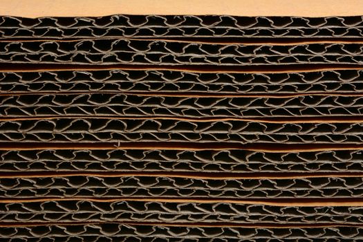 Closeup side view of a stacked corrugated cardboard