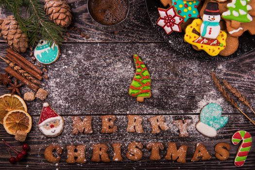 Gingerbreads and coffee for new years and christmas on wooden background, xmas theme