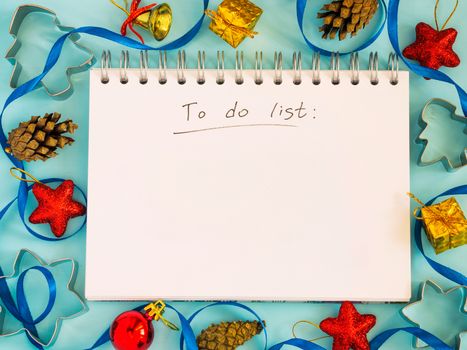 Christmas background with to-do list and decorations. Copy space. Top view or flat lay. Toned image
