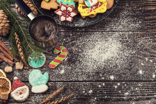 Gingerbreads and coffee for new years and christmas on wooden background, xmas theme