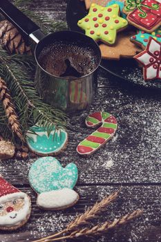 Gingerbreads and coffee for new years and christmas on wooden background, xmas theme