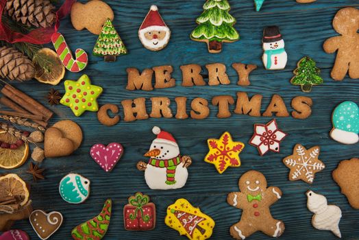 Gingerbreads for new years and christmas on wooden background with space for design