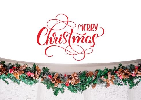 decor of spruce branches with buds and text Merry Christmas. Calligraphy lettering.