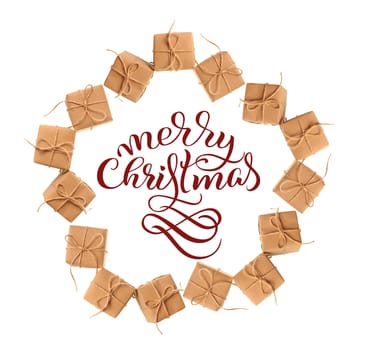gift boxes of kraft paper isolated on a white background and text Merry Christmas. Calligraphy lettering.