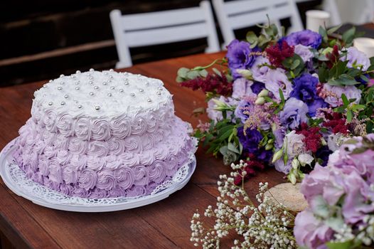 festive wedding cake and a bouquet of flowers on the table.