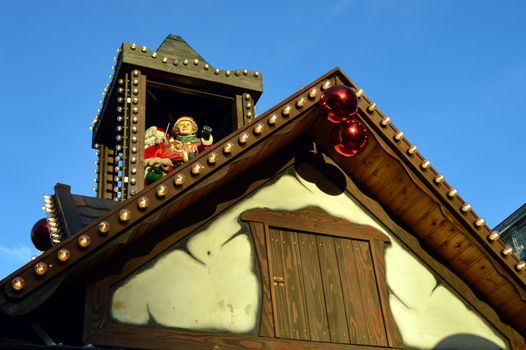 Mom and papa christmas on a wooden tower on a cottage