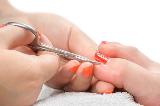 beauty treatment, body care series. pedicure applying - toe nails cleaning, cuticle cutting