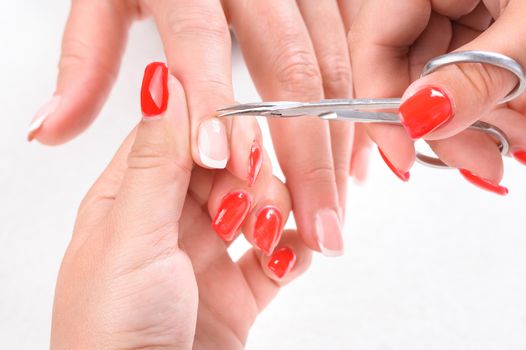 Nail salon, hands beauty treatment, cuticles cutting with cuticle pusher