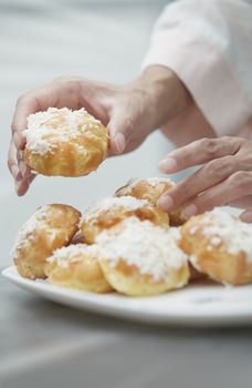 Woman eating eclairs at home. Vertical photos