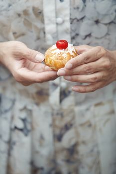 Woman holding Christmas eclair at home