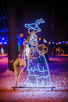 Christmas illumination in the Park - woman with umbrella.