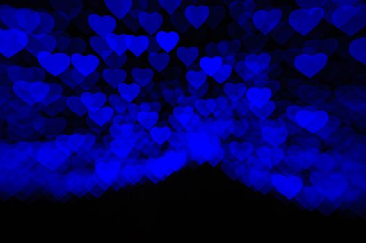 abstract black background with soft blue hearts.