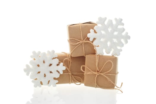 Holiday boxes and toy snowflakes on white background.