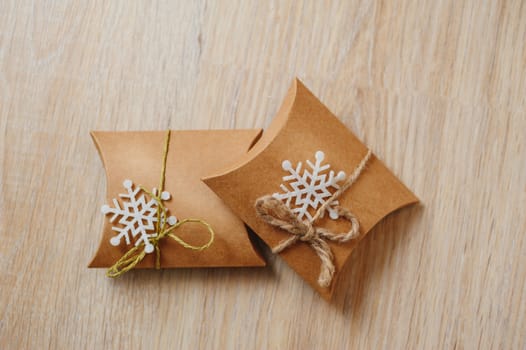 gift boxes of kraft paper on wooden background.