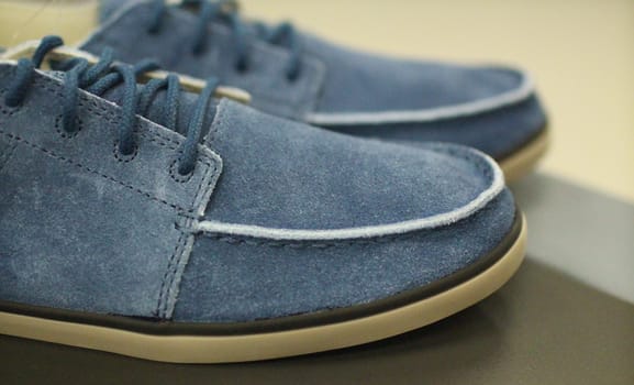 pair of blue suede shoes for men shallow depth of field