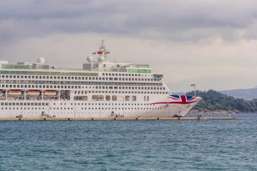 large white ship sailing in blue sea shore lengthwise