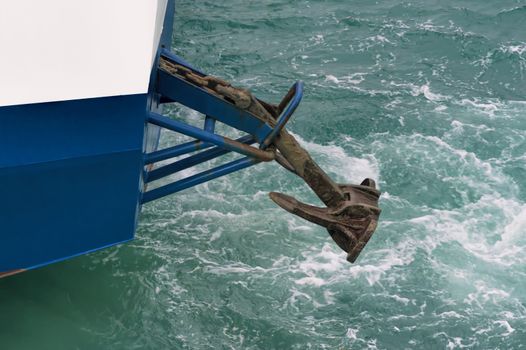 large white ship sailing in blue sea with raised anchor